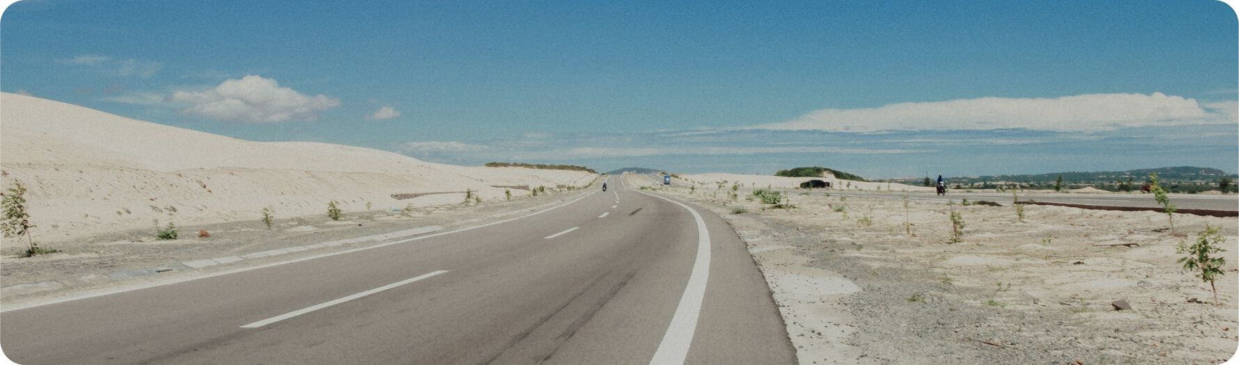 Paved road through sandy terrain